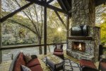 Covered Deck with fireplace over looking Toccoa River